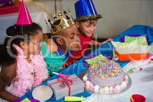 Boy blowing candles on cake