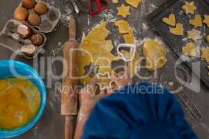 Cropped image of boy preparing cookies