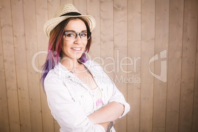 Girl in spectacles posing with her arms crossed
