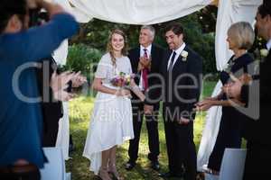 Guests clapping for newly married couple