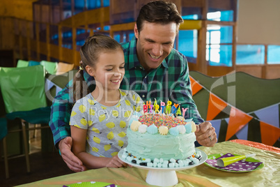 Father and daughter with birthday cake