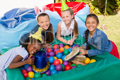 High angle portrait of female friends by ball pool