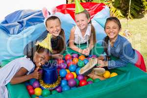 High angle portrait of female friends by ball pool