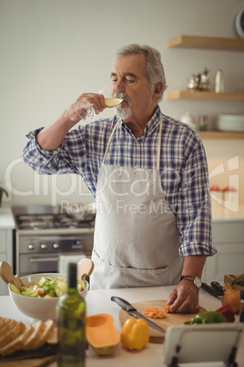 Senior man drinking a glass of wine