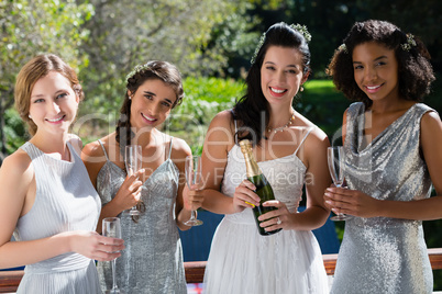 Bride and bridesmaids having champagne