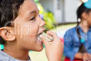 Close up of boy eating cake