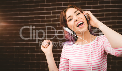 Portrait of smiling woman listening music on headphones