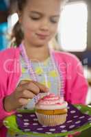 Birthday girl holding a cupcake