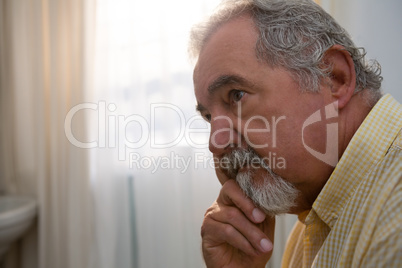 Close up of thoughtful senior man looking away