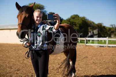 Girl taking a selfie with horse