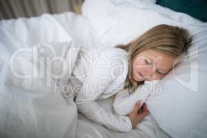 Girl sleeping on bed in bedroom