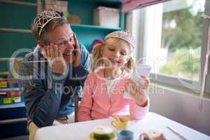 Father and daughter in fairytale dressing taking a selfie