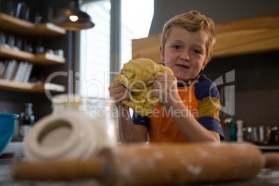 Portrait of boy kneading dough