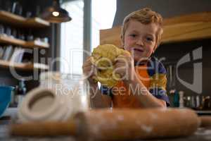Portrait of boy kneading dough