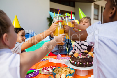 Children toasting juice