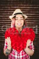 Smiling woman holding heart shape