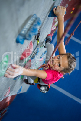 Portrait of teenage girl practicing rock climbing
