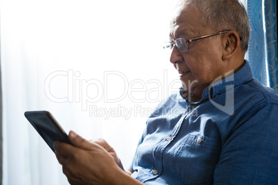 Senior man using tablet at nursing home