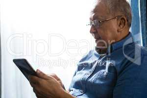 Senior man using tablet at nursing home