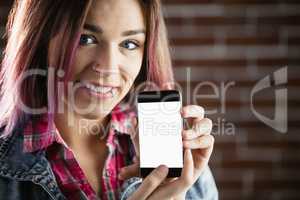 Portrait of smiling woman showing mobile phone
