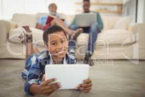 Boy using digital tablet in living room