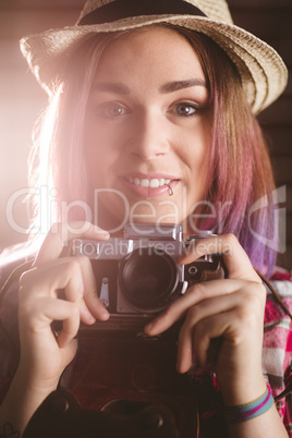 Portrait of smiling woman holding vintage camera