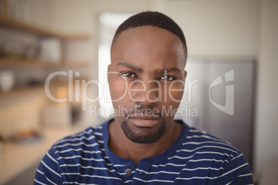 Confident man looking at camera in kitchen