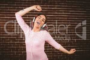 Portrait of smiling woman listening music on headphones