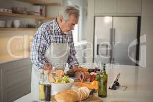 Senior man chopping vegetables