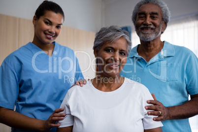 Portrait of seniors with nurse in retirement home