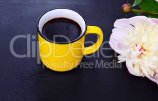 Yellow cup with black coffee