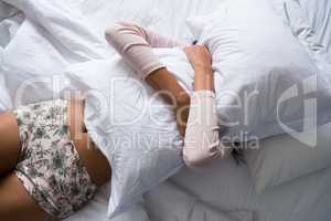 Woman holding pillow on bed