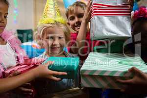 Portrait of smiling girl receiving gifts from friends