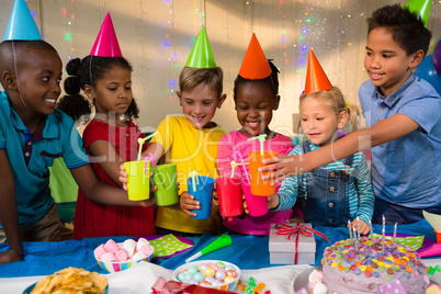 Happy children toasting drinks