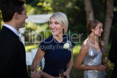 Happy guests having champagne during wedding