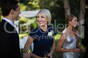 Happy guests having champagne during wedding