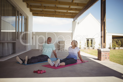 Senior couple relaxing on exercise mat