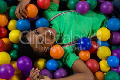 Overhead portrait of boy in ball pool