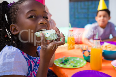 Portrait of girl eating cake