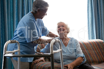 Nurse helping senior woman in standing