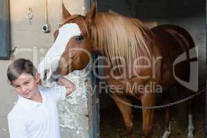 Rider boy caressing a horse