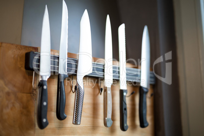 Set of kitchen knives hanging on the wall