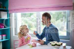 Father and daughter playing a tea set role play
