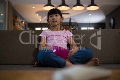 Girl relaxing on sofa at home