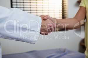Physiotherapist shaking hand with patient