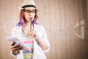 Thoughtful woman holding notepad and pen