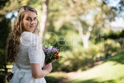 Portrait of beautiful bride holding bouquet