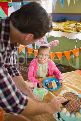 Father and daughter celebrating birthday at home