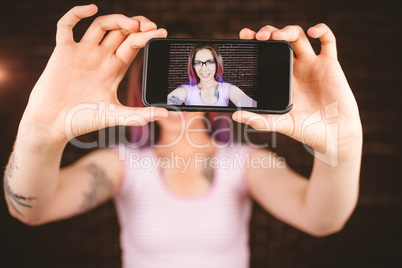 Smiling woman taking selfie from mobile phone