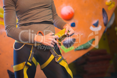 Mid section of woman wearing safety harness